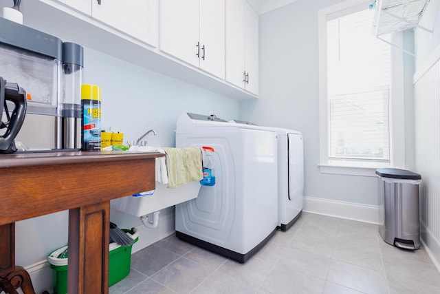 3025 Rampart Rd, Summerville, SC 29483 - laundry area with washer and dryer, cabinet space, light tile patterned floors, and baseboards