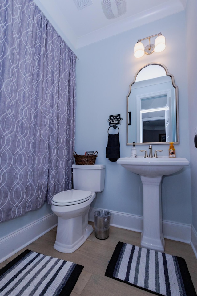 3025 Rampart Rd, Summerville, SC 29483 - full bath with wood finished floors, toilet, and baseboards