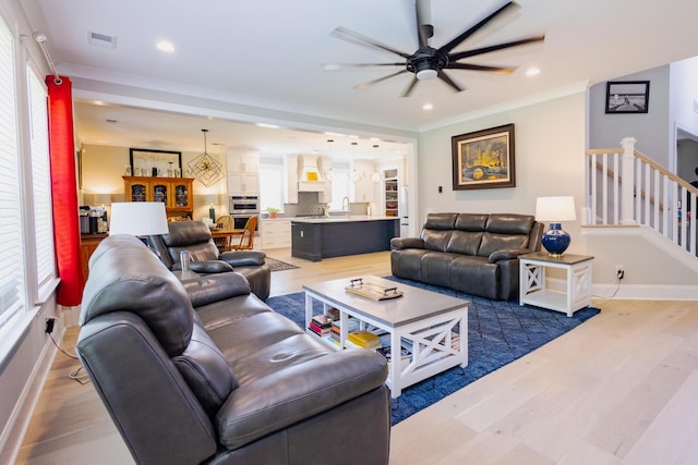 3025 Rampart Rd, Summerville, SC 29483 - living room featuring crown molding, plenty of natural light, ceiling fan, light wood-type flooring, and baseboards