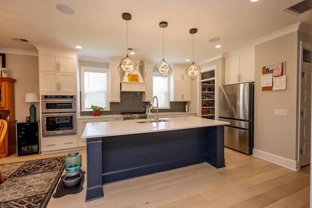 3025 Rampart Rd, Summerville, SC 29483 - kitchen with stainless steel appliances, a sink, backsplash, white cabinets, and ornamental molding