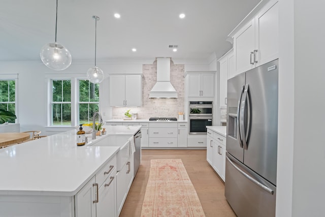 5710 Barbary Coast Rd, Hollywood, SC 29449 - kitchen featuring appliances with stainless steel finishes, premium range hood, plenty of natural light, light countertops, and recessed lighting