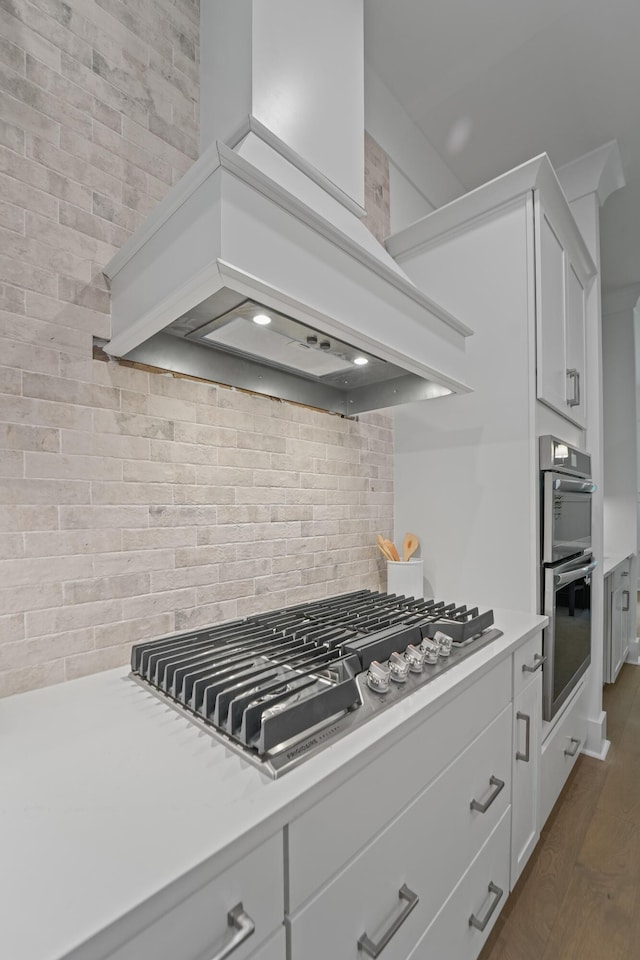 5710 Barbary Coast Rd, Hollywood, SC 29449 - kitchen featuring premium range hood, appliances with stainless steel finishes, light countertops, and dark wood finished floors