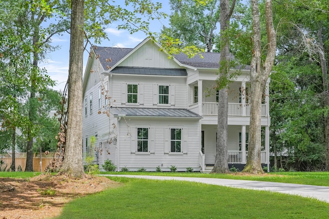 5710 Barbary Coast Rd, Hollywood, SC 29449 - view of front facade featuring covered porch, board and batten siding, a standing seam roof, a balcony, and a front lawn