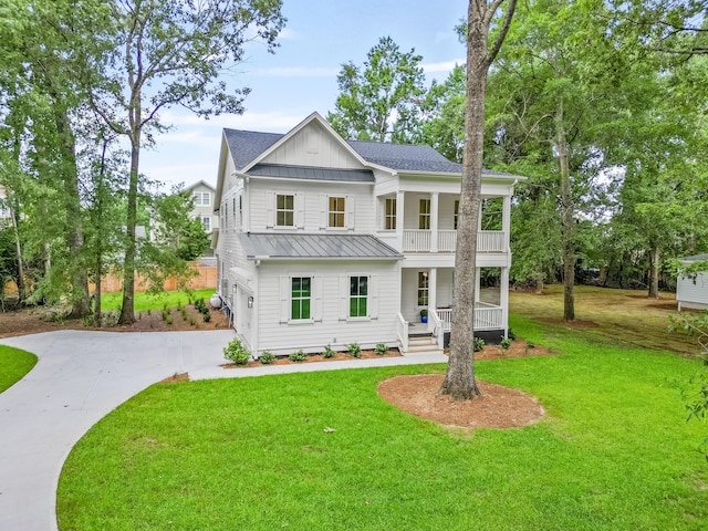 5710 Barbary Coast Rd, Hollywood, SC 29449 - modern inspired farmhouse with covered porch, a standing seam roof, driveway, board and batten siding, and a front lawn