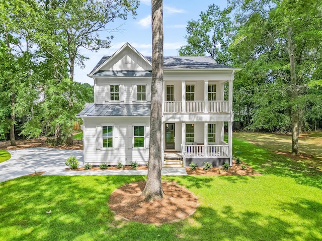 5710 Barbary Coast Rd, Hollywood, SC 29449 - greek revival house featuring covered porch, a balcony, a front lawn, and a standing seam roof