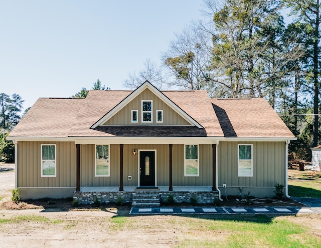 view of front of house with roof with shingles and covered porch