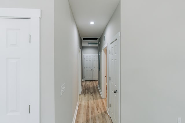 hall with light wood-type flooring, recessed lighting, and baseboards