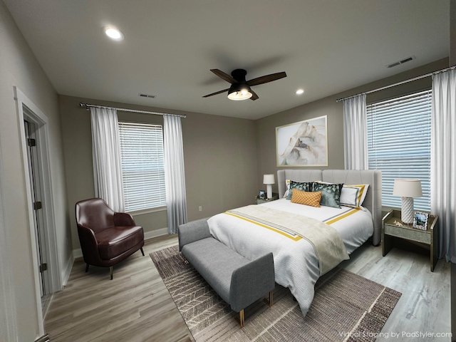 bedroom with visible vents, baseboards, and light wood-type flooring