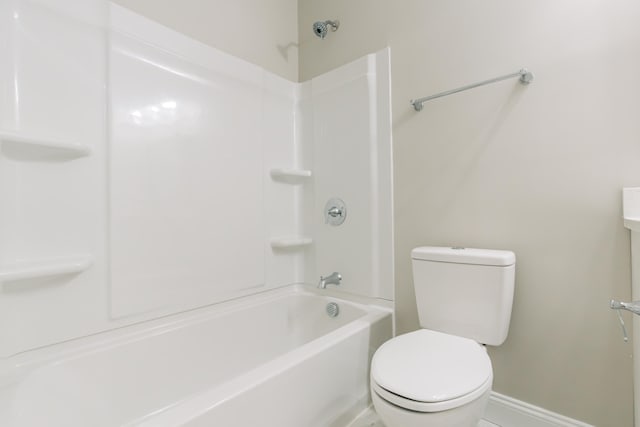 bathroom with baseboards and toilet