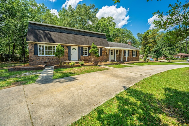 100 Colonial Dr, Goose Creek, SC 29445 - view of front of house featuring a shingled roof, a front lawn, and brick siding