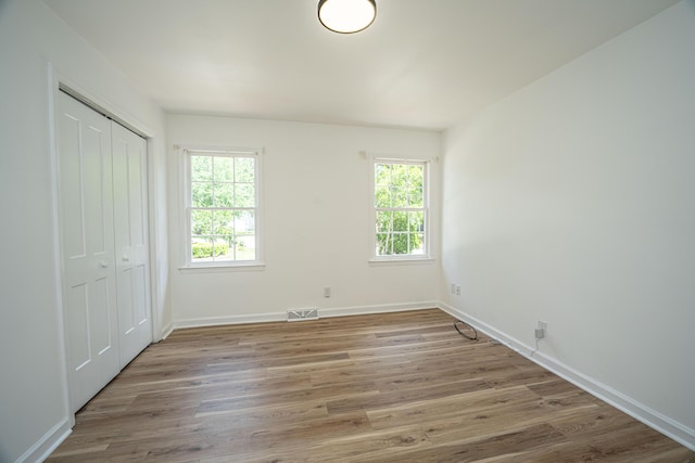 100 Colonial Dr, Goose Creek, SC 29445 - unfurnished bedroom featuring a closet, visible vents, wood finished floors, and baseboards