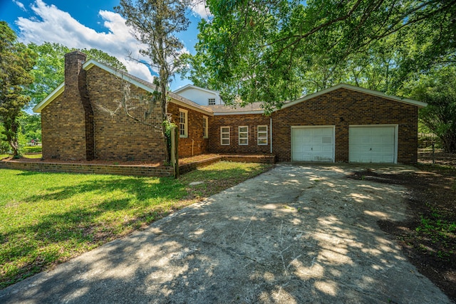 100 Colonial Dr, Goose Creek, SC 29445 - view of front of home with a chimney, brick siding, a garage, concrete driveway, and a front yard