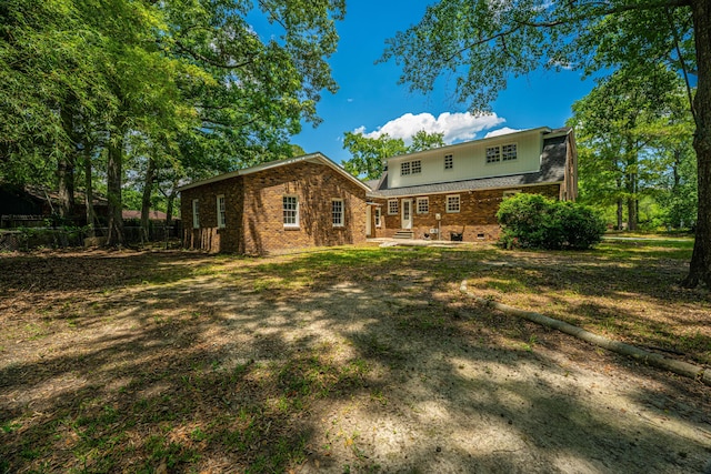 100 Colonial Dr, Goose Creek, SC 29445 - rear view of property featuring brick siding, fence, and a patio