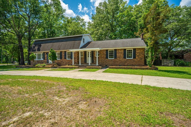 100 Colonial Dr, Goose Creek, SC 29445 - dutch colonial featuring roof with shingles, fence, brick siding, crawl space, and a front lawn