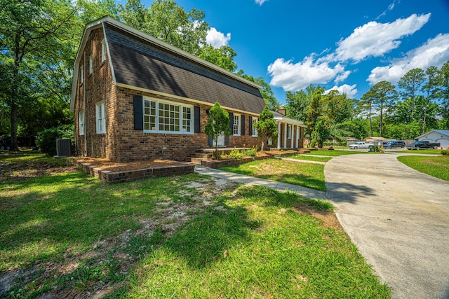 100 Colonial Dr, Goose Creek, SC 29445 - dutch colonial with cooling unit, driveway, a front lawn, brick siding, and roof with shingles