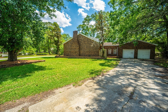 100 Colonial Dr, Goose Creek, SC 29445 - view of front of home featuring a chimney, driveway, a front lawn, and a garage