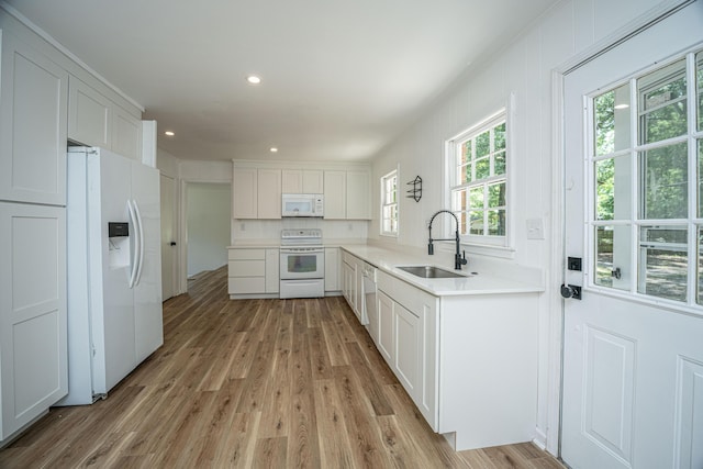 100 Colonial Dr, Goose Creek, SC 29445 - kitchen featuring a sink, light wood finished floors, white appliances, and white cabinets