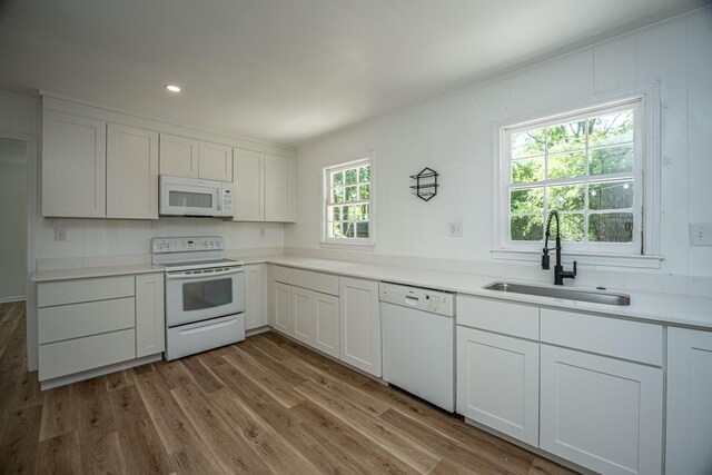 100 Colonial Dr, Goose Creek, SC 29445 - kitchen with a sink, white appliances, light countertops, white cabinets, and light wood-style floors