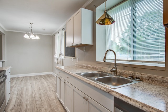 2702 Decatur St, North Charleston, SC 29405 - kitchen with a sink, crown molding, decorative light fixtures, light wood finished floors, and light countertops