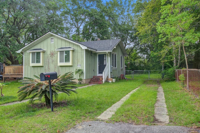 2702 Decatur St, North Charleston, SC 29405 - bungalow-style home with entry steps, a shingled roof, board and batten siding, a deck, and a gate