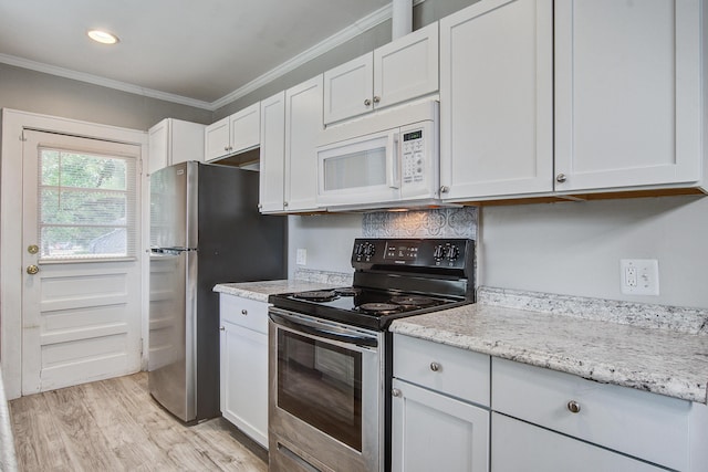 2702 Decatur St, North Charleston, SC 29405 - kitchen with appliances with stainless steel finishes, ornamental molding, white cabinets, light wood-type flooring, and light stone countertops
