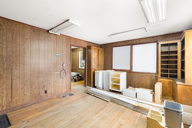 spare room with wooden walls and light hardwood / wood-style floors