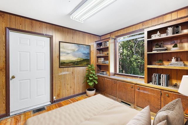 home office featuring wooden walls and light hardwood / wood-style floors