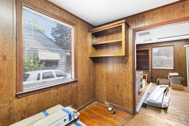 interior space with wood-type flooring and wood walls