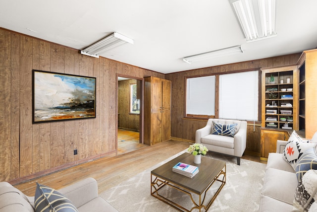 living room featuring wood walls and light hardwood / wood-style flooring