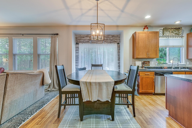 dining space with light wood-type flooring, a chandelier, and recessed lighting