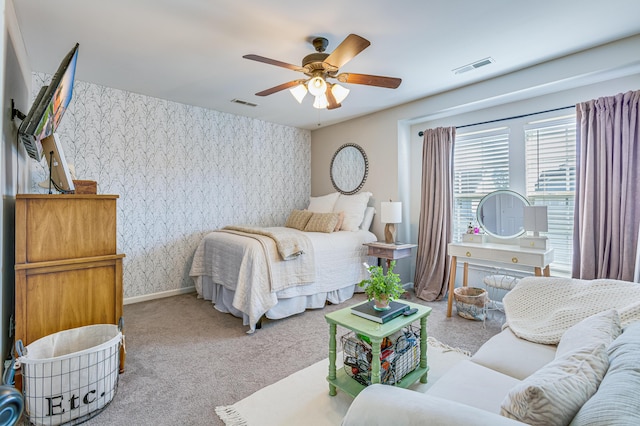 bedroom with wallpapered walls, carpet floors, ceiling fan, and baseboards