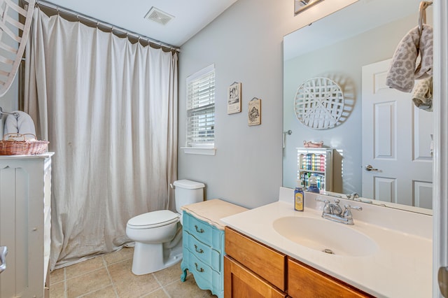 bathroom featuring toilet, vanity, a shower with shower curtain, and tile patterned floors