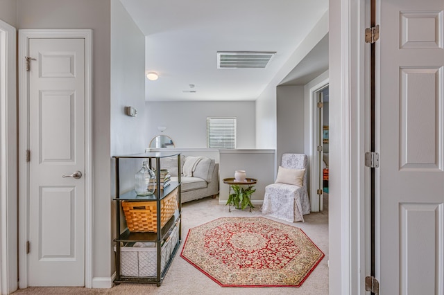 living area featuring carpet floors and baseboards