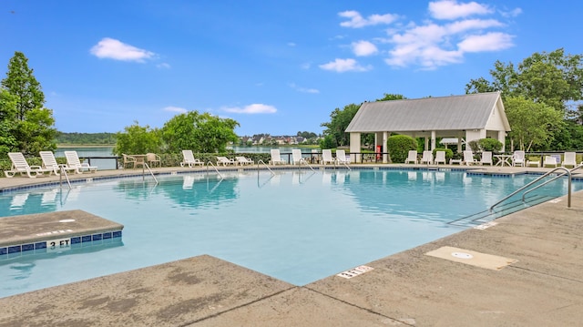 community pool with fence and a patio