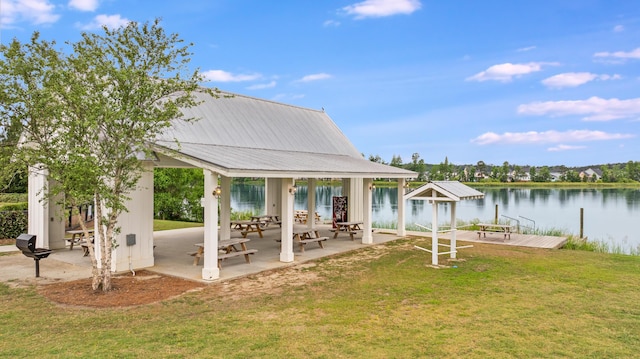 view of grassy yard with a water view, a gazebo, and a patio