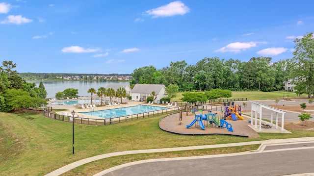 community pool with a water view and view of scattered trees
