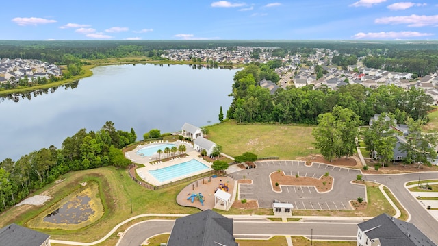 aerial view of residential area featuring a large body of water and a pool