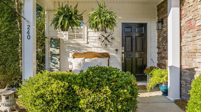 view of exterior entry with covered porch