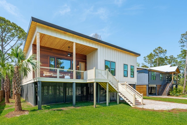 1012 E Erie Ave, Folly Beach, SC 29439 - rear view of house featuring stairway, a ceiling fan, a lawn, and board and batten siding