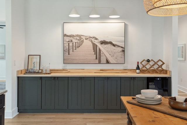 1012 E Erie Ave, Folly Beach, SC 29439 - indoor dry bar with light wood-type flooring, beverage cooler, hanging light fixtures, and baseboards