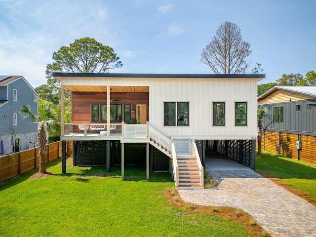 1012 E Erie Ave, Folly Beach, SC 29439 - back of property with ceiling fan, a carport, decorative driveway, stairs, and board and batten siding