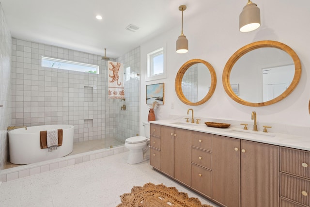 1012 E Erie Ave, Folly Beach, SC 29439 - bathroom with double vanity, tiled shower, a soaking tub, and toilet