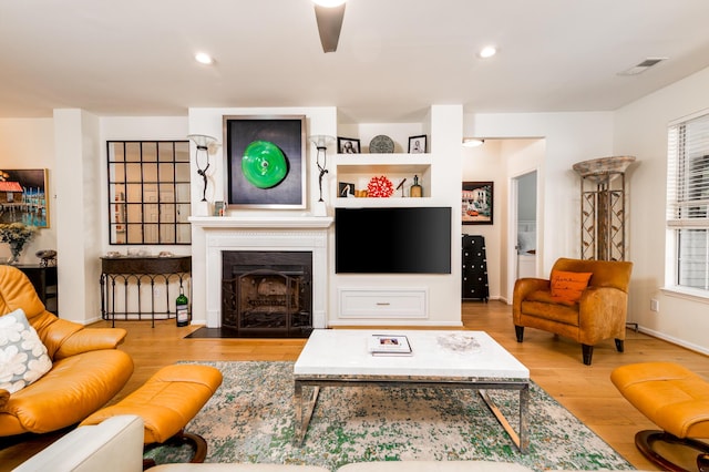 1231 Wild Olive Dr, Mount Pleasant, SC 29464 - living area featuring wood finished floors, a fireplace with flush hearth, recessed lighting, and baseboards