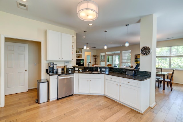1231 Wild Olive Dr, Mount Pleasant, SC 29464 - kitchen featuring stainless steel dishwasher, a sink, open shelves, light wood finished floors, and healthy amount of natural light