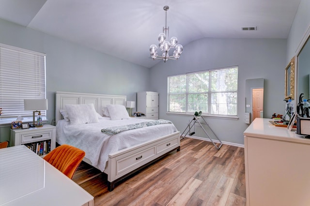 1231 Wild Olive Dr, Mount Pleasant, SC 29464 - bedroom with a chandelier, vaulted ceiling, light wood-style flooring, and baseboards