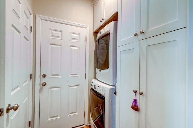 1231 Wild Olive Dr, Mount Pleasant, SC 29464 - laundry room featuring stacked washing machine and dryer and cabinet space