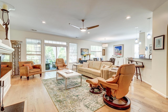 1231 Wild Olive Dr, Mount Pleasant, SC 29464 - living room featuring light wood-style flooring, a ceiling fan, a fireplace, recessed lighting, and baseboards