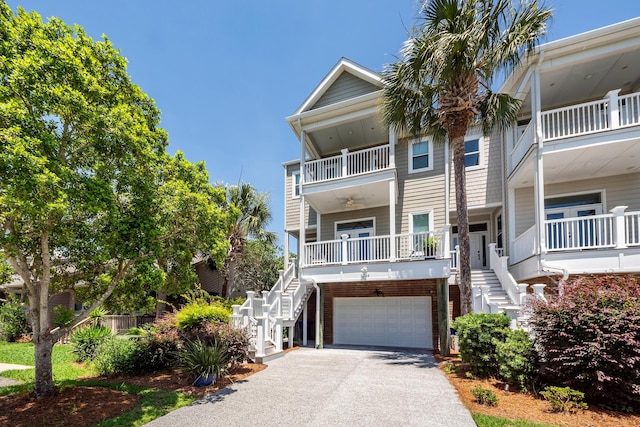 2226 Folly Rd, Charleston, SC 29412 - coastal inspired home with stairs, asphalt driveway, and a garage