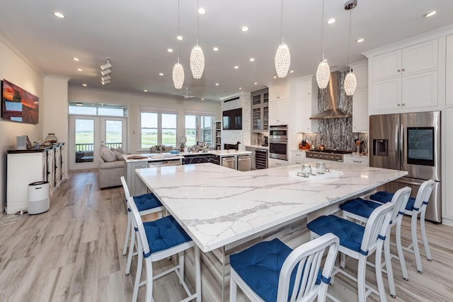 2226 Folly Rd, Charleston, SC 29412 - kitchen with appliances with stainless steel finishes, a large island, recessed lighting, crown molding, and backsplash
