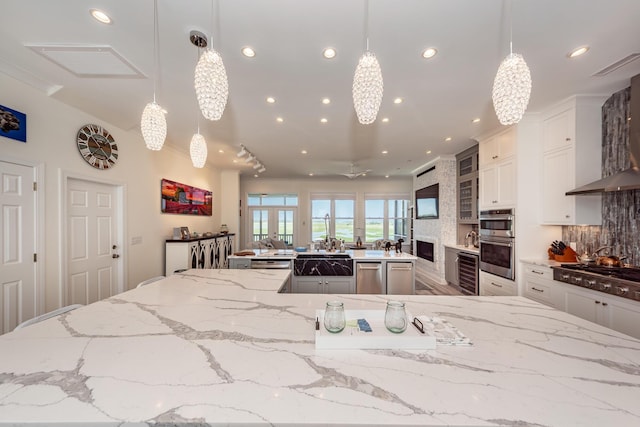 2226 Folly Rd, Charleston, SC 29412 - kitchen with appliances with stainless steel finishes, a spacious island, recessed lighting, backsplash, and light stone countertops